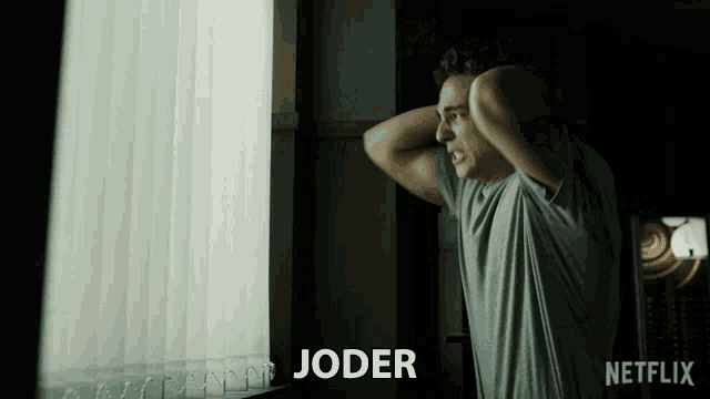 a man is looking out a window with the word joder written below him