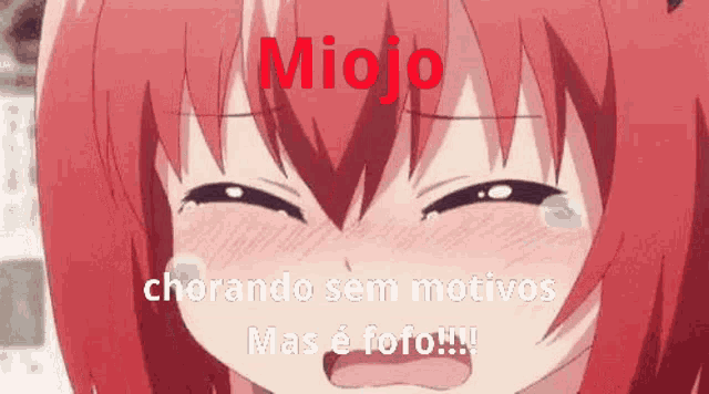 a red haired anime girl is crying with a tear coming out of her eyes .