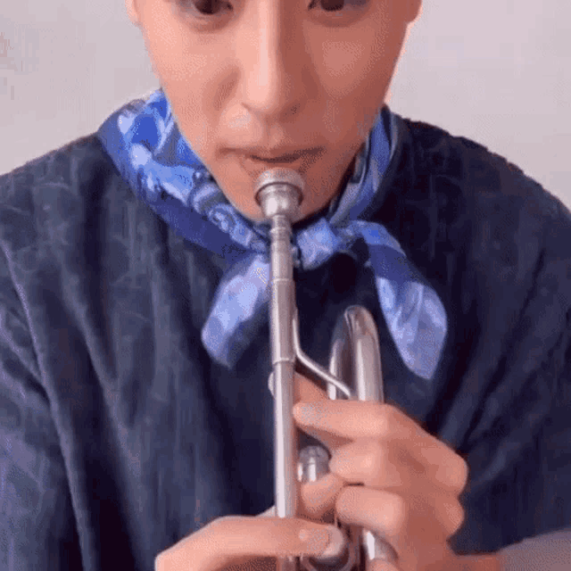 a close up of a person playing a trumpet .