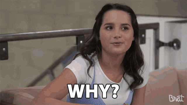 a girl is sitting on a couch and says " why "