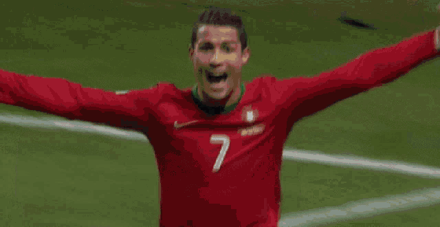 a blurry picture of a person in a red shirt on a field