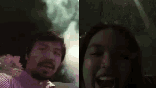 a man and a woman are standing next to each other in a dark room and laughing .