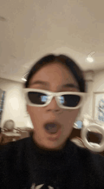 a blurry picture of a girl wearing sunglasses