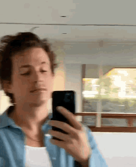 a man is taking a picture of himself with his phone