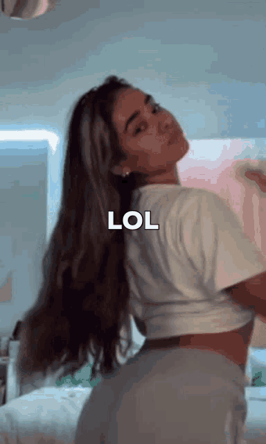 a woman with long hair is posing for a picture with the word lol on the bottom