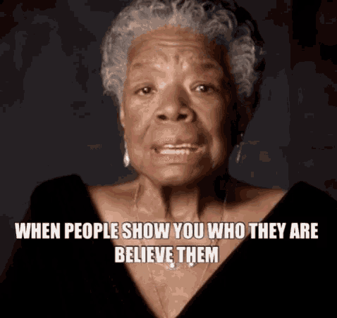 a woman with gray hair and a black shirt says when people show you who they are believe them