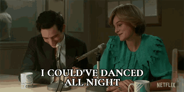 a man and a woman sitting in front of microphones with the words i could 've danced all night