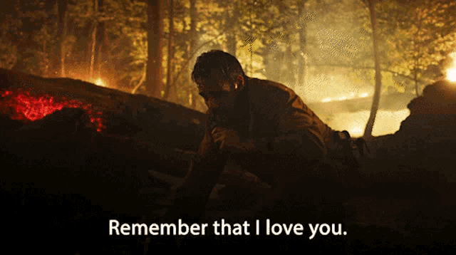 a man in a dark forest with the words remember that i love you on the bottom