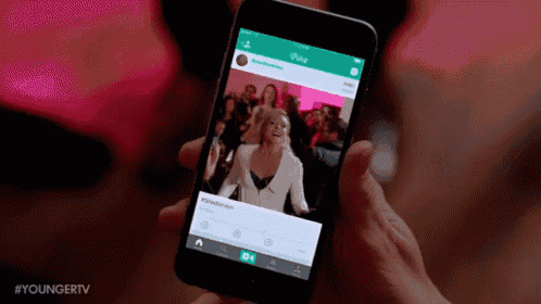 a woman is holding a cell phone with a picture of a woman on the screen .