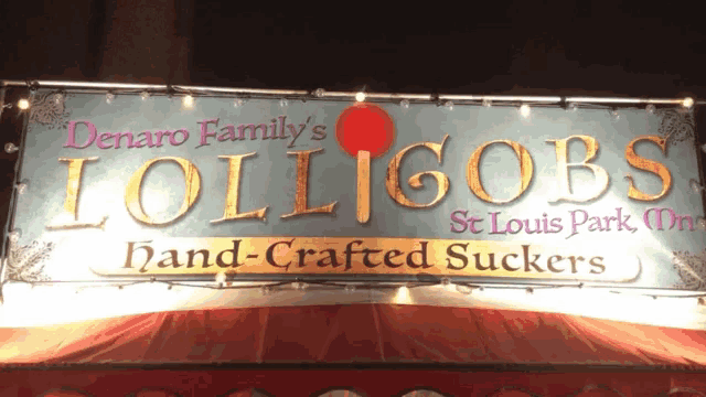 a sign that says denaro family 's lollipops hand crafted suckers