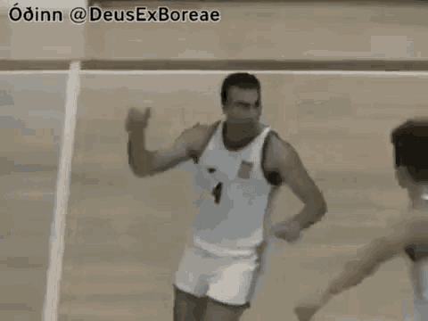two men are playing basketball on a court and one of them is wearing a number 4 jersey .