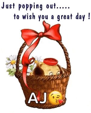 a dog is sitting in a basket with flowers and a bow .