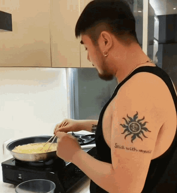 a man with a tattoo that says stick with myself on his arm
