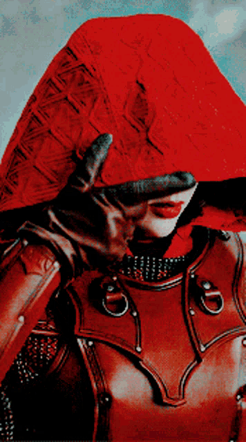 a woman wearing a red hood and leather armor