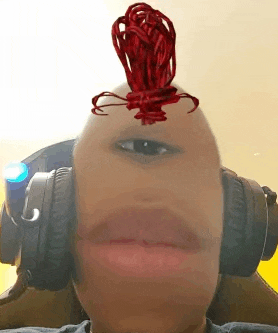 a person wearing headphones and a mohawk with a red ribbon on their head .