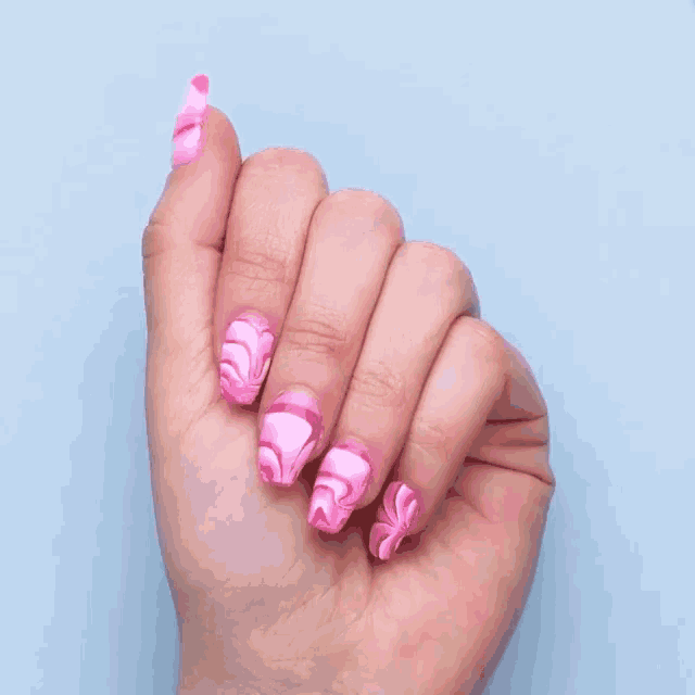 a close up of a person 's hand with pink nails