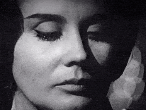 a close up of a woman 's face with a shadow on her face