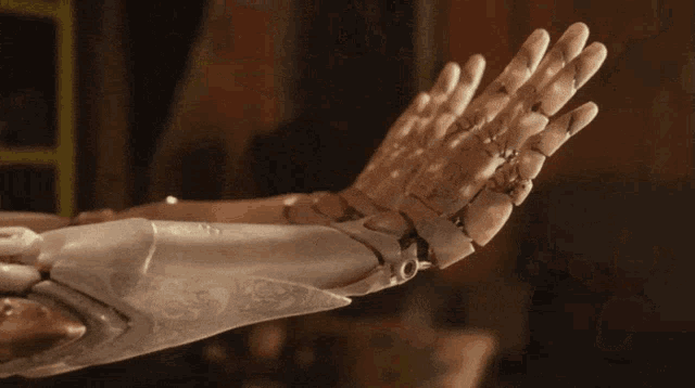 a close up of a robotic arm with a swirl design