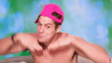 a shirtless man wearing a pink baseball cap is making a face .