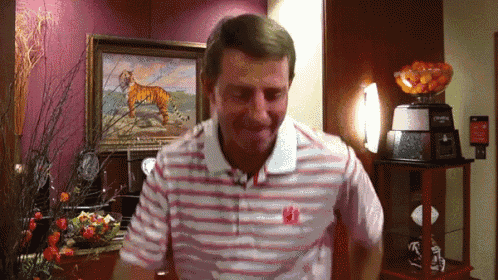a man wearing a striped shirt with the letter w on the front