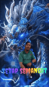 a man in a green shirt is sitting in front of a blue dragon with the words " tetap semangat " on the bottom