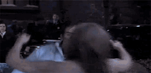 a blurry picture of two men boxing in a boxing ring .