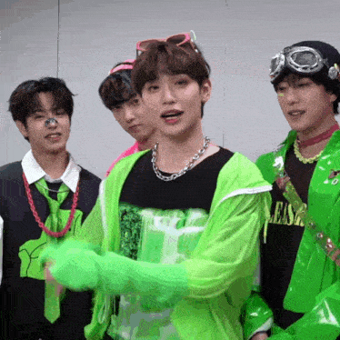 a group of young men are wearing neon green outfits and one of them is wearing a shirt that says lease on it