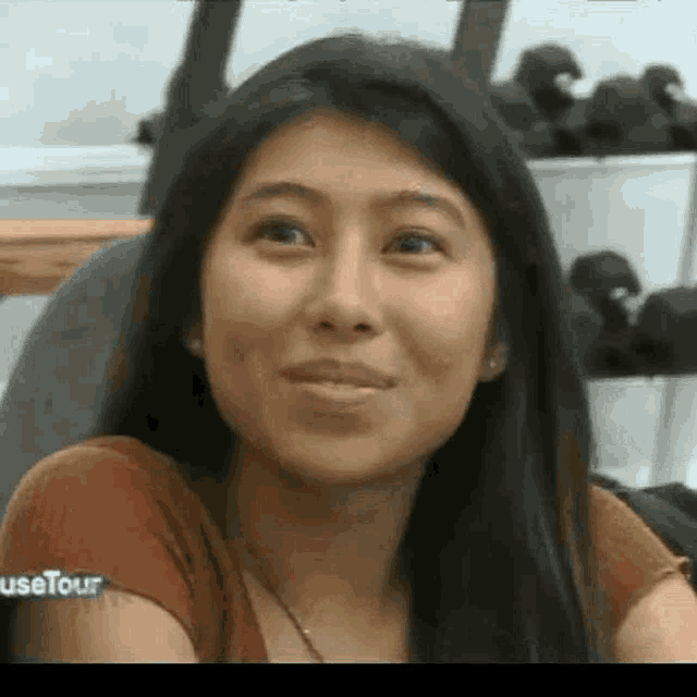 a close up of a woman 's face with a smile on her face .