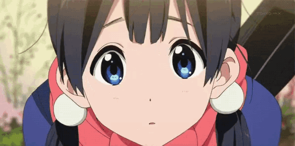 a girl with blue eyes is wearing a scarf and earrings .