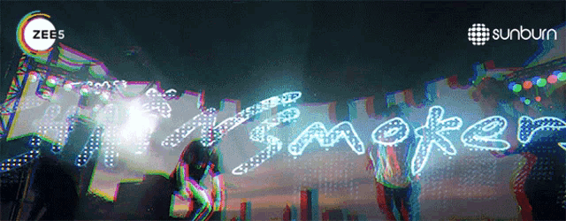 a poster for zee5 shows a group of people dancing in front of a sign that says time maker