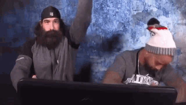 a man with a beard is wearing a t-shirt that says patriots