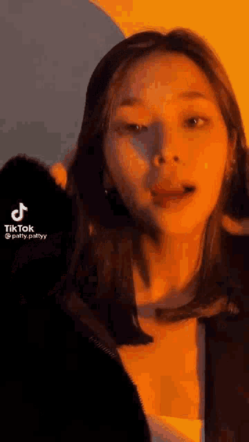 a close up of a woman 's face with a tik tok video of her .