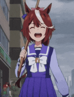 a girl in a sailor uniform is holding a stick and laughing .