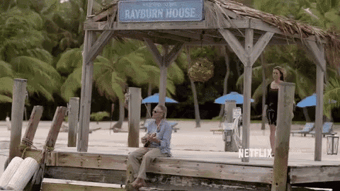 a man is sitting on a dock under a gazebo that says rayburn house