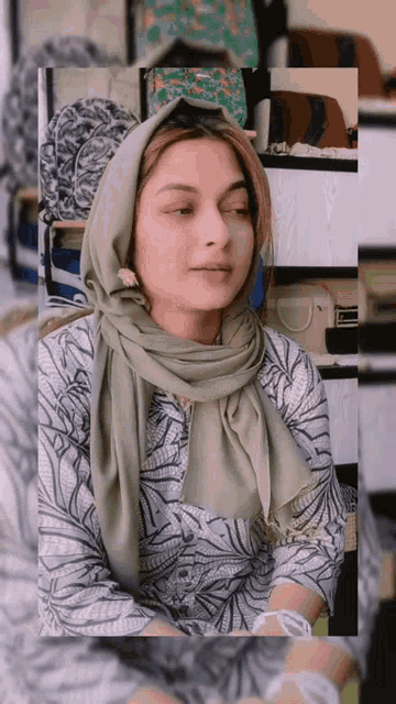 a woman wearing a scarf and a shirt with a pattern