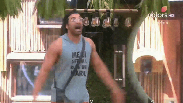 a man wearing a blue tank top that says meri lifenaal kyun bi maru