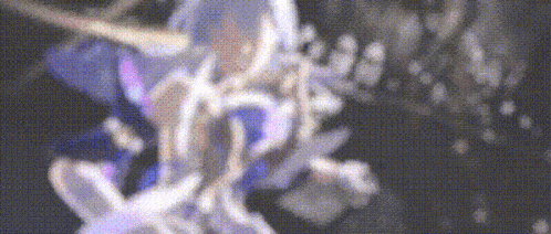 a blurry picture of a person in a purple and white dress with a sword .