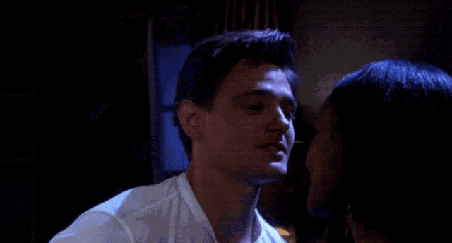 a man and a woman are looking into each others eyes