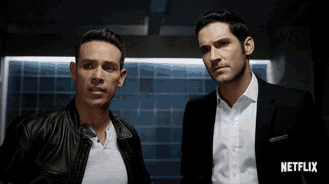 two men are standing next to each other with a netflix logo in the background