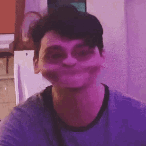 a man in a purple shirt is making a strange face
