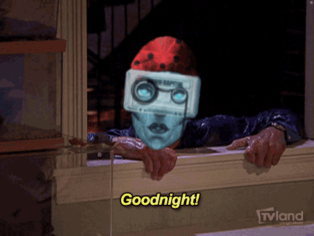 a man with a cassette tape on his head is looking out a window and saying goodnight
