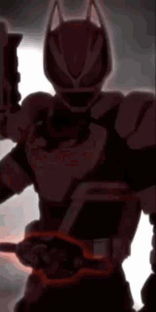 a silhouette of a robot holding a gun in the dark