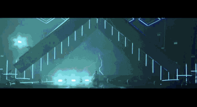 a man is standing in front of a stage with a lightning bolt in the background