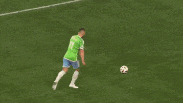 a soccer game is being played in front of a sign that says " adidas "