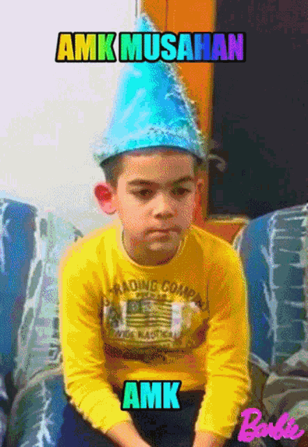 a young boy wearing a party hat is sitting on a couch with the words amk musahan above him