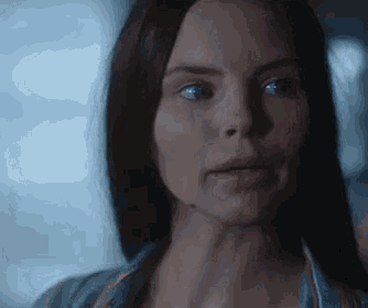 a close up of a woman 's face with a serious look on her face