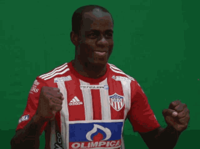 a man wearing a red white and blue shirt with the word olimpica on it
