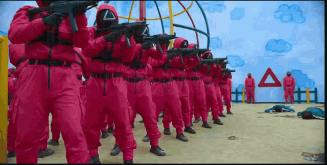a group of people in pink uniforms with guns