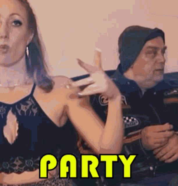 a man and a woman are sitting on a couch with the word party in yellow letters .