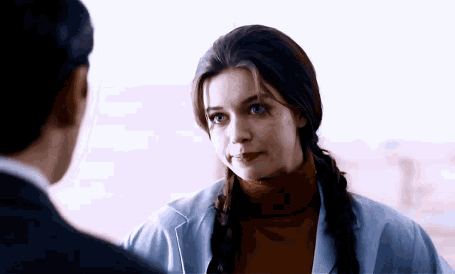 a woman with pigtails is looking at a man